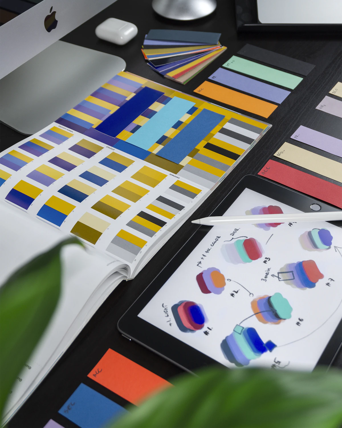 Open color palette reference book showing a spectrum of brand swatches