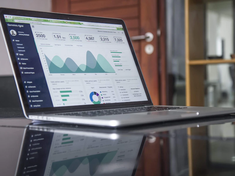 Laptop on a desk displaying a website design layout