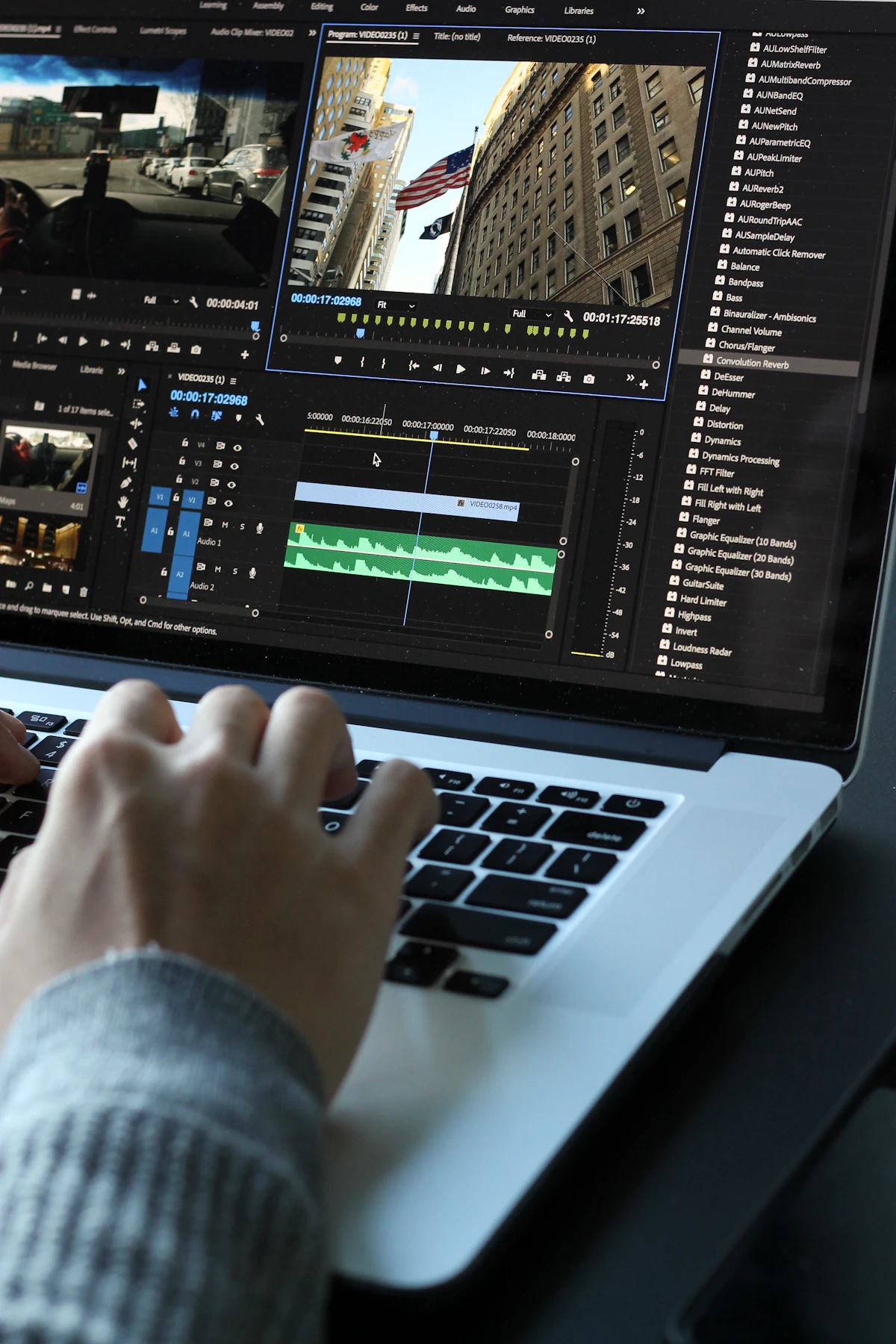 Video editor working on a laptop in a creative studio environment